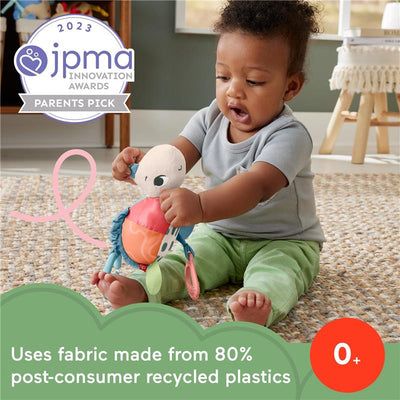 Infant playing with Fisher Price Planet Friends Sea Me Bounce Turtle plush toy, featuring teething rings and colorful fabric.