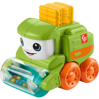 Green push-along tractor toy featuring a smiling face, transparent front with colorful beads, and yellow cargo on top.