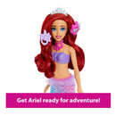 Mermaid doll Ariel wearing a purple top and pink skirt, styled with a tiara and accessories, ready for play.