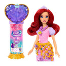 Disney Princess Ariel fashion doll with vibrant red hair, in a sparkly pink dress and jewel accessories, alongside a surprise reveal packaging.