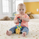 Baby sitting on a rug, holding Fisher Price Laugh & Learn keys toy, featuring colorful buttons and a small dog character.