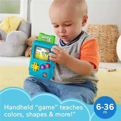 Toddler engaged with Fisher Price Laugh & Learn Lil’ Gamer, a colorful handheld toy teaching colors and shapes.