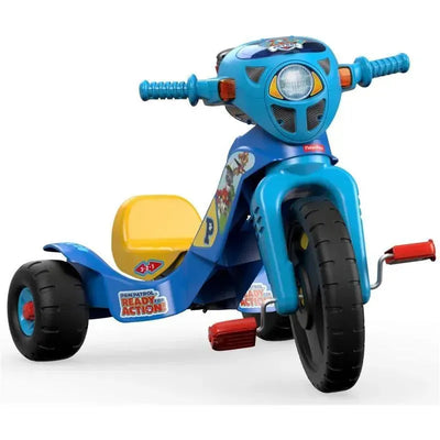 Paw Patrol-themed tricycle in blue and yellow, featuring a front headlight and cartoon dog characters on the side.