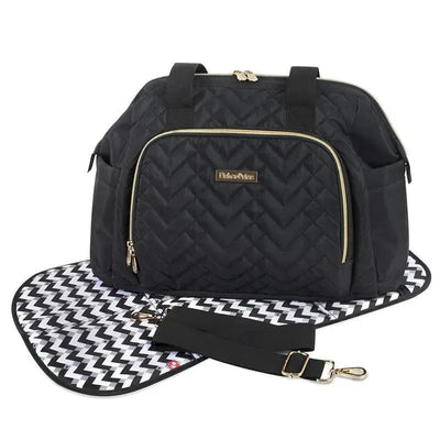 Quilted black diaper bag tote with a gold zipper, adjustable strap, and a patterned changing mat.