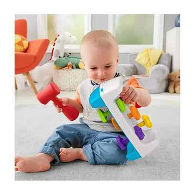 Toddler playing with the Fisher Price Tap & Turn Bench, which has colorful buttons and a toy hammer.