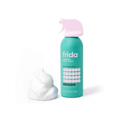 Whipped body wash spray bottle in teal, featuring aloe and vanilla bean scent, with foamy product beside it.