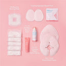 Frida Mom 13Pk Breastfeeding Survival Kit includes nursing pads, nipple balm, saline spray, and relief packs on a pink background.