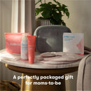 Frida Mom 13Pk Breastfeeding Survival Kit featuring nipple balm, saline spray, hydrogel pads, and a storage pouch on a table.