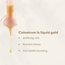 Frida Mom 15Pk Colostrum Collection Kit with colostrum dripping, highlighting its benefits: antibody rich, nutrient dense, gut health boosting.