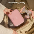 Frida Mom 15Pk Colostrum Collection Kit in a pink case being placed into a hospital bag beside a breast pump.