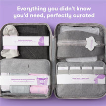 Frida Mom 30Pk travel bag displaying postpartum recovery essentials, with labeled compartments and soft items visible inside.