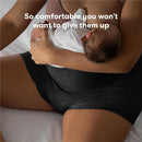 Postpartum woman wearing Frida Mom disposable boyshort panties while nursing a baby, highlighting comfort and support.
