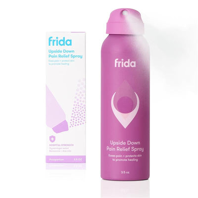 Frida Mom Anesthetic Spray 3.5 oz in a pink bottle next to its packaging; promotes postpartum pain relief and healing.