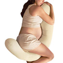 Pregnant woman in a sleeveless top and striped shorts cuddling an ivory Frida Mom 4-in-1 Cooling Pregnancy Pillow.