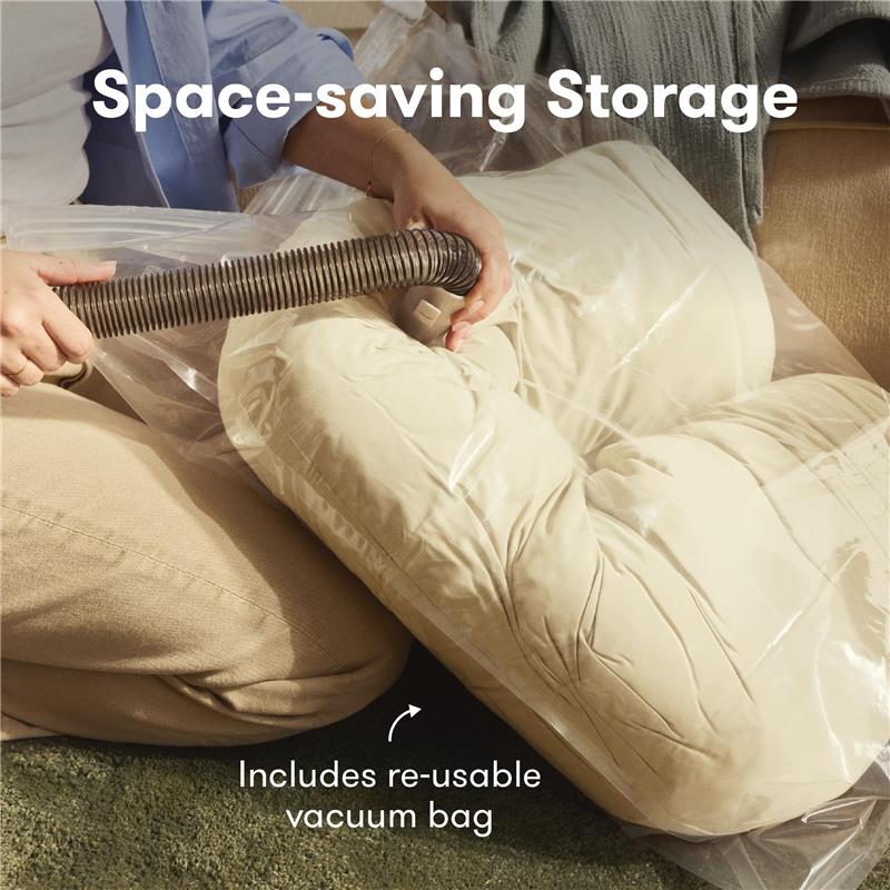 Frida Mom Compact Support 4-in-1 Cooling Pregnancy Pillow being vacuum sealed in a clear bag, showing a re-usable vacuum bag.