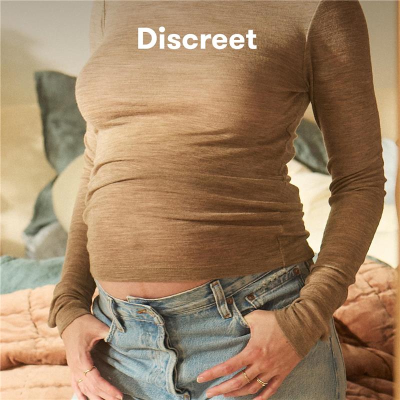 Frida Mom Dual Support Pregnancy Belly Band shown on a pregnant person, emphasizing discreet support for the baby bump.