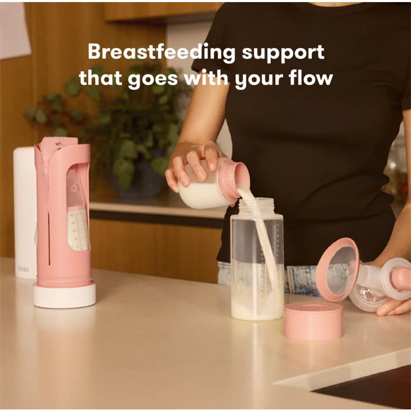 Frida Mom Flow + Go Breastmilk Cooler on a kitchen counter, with a person pouring breastmilk into a container.