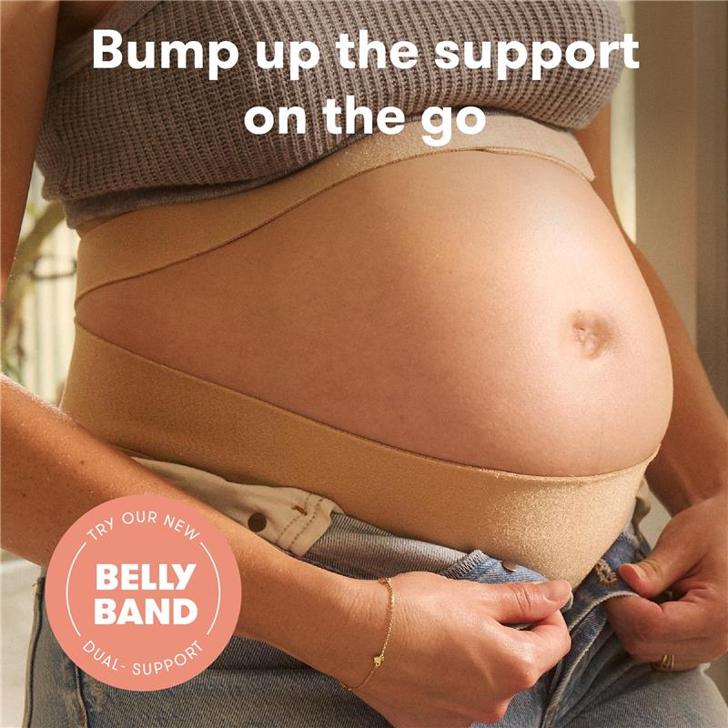 Frida Mom Belly Band providing support for a pregnant belly, woman adjusting the band while wearing jeans.