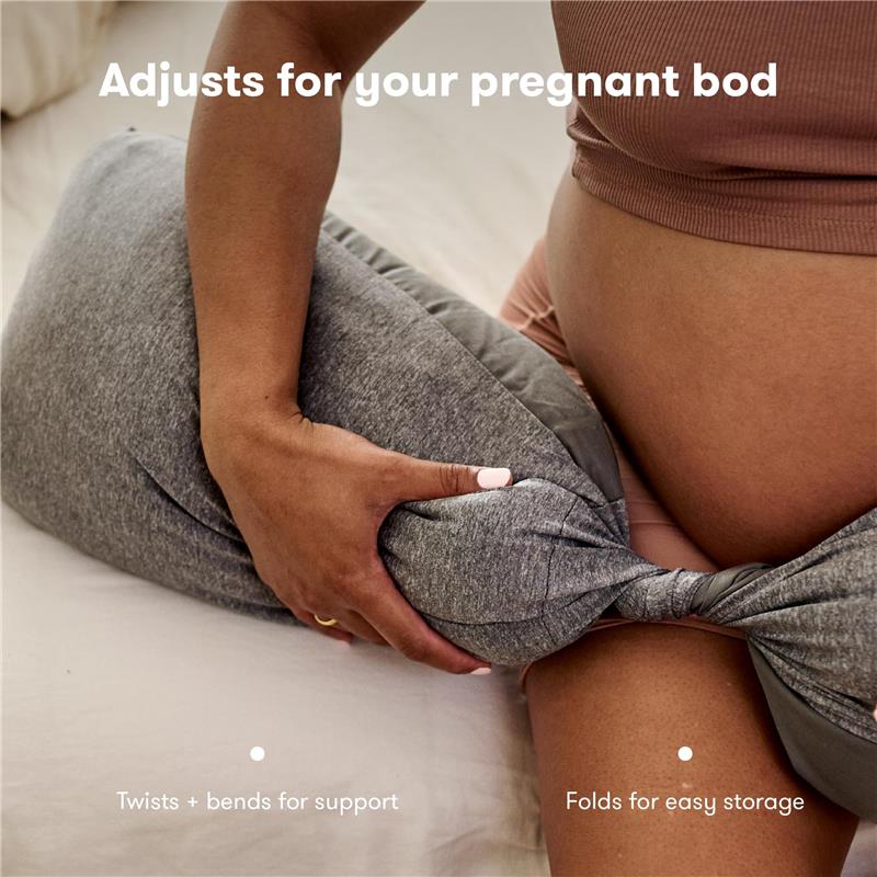 Adjustable gray body pillow designed for pregnancy support, being held by a person with a visible baby bump.