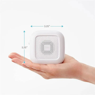Portable Fridababy sound machine and nightlight in a hand, measuring 3.25 inches square.