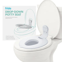 FridaBaby Drop Down Potty Training Seat for toddlers, designed to fit most toilets, shown mounted on a white toilet.