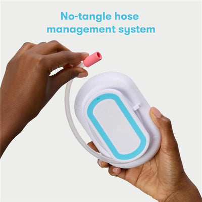 Electric Nosefrida Pro with a no-tangle hose management system, held by a hand, showcasing its design features.