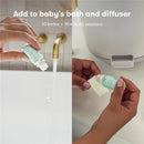 FridaBaby Eucalyptus & Lavender Essential Oil bottle held above a bathtub faucet, ready for use in bath or diffuser.