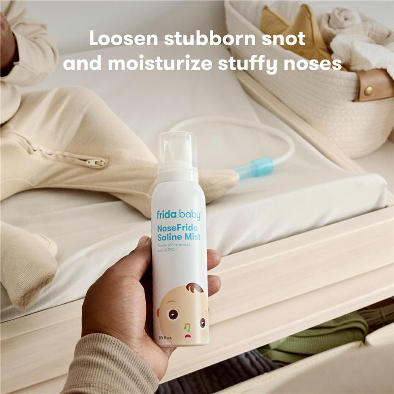FridaBaby NoseFrida Saline Mist Spray in a hand, 3.4 oz, designed to loosen nasal congestion and moisturize.