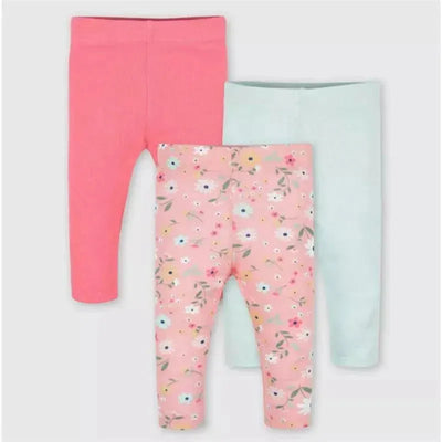 Three pairs of baby girl pants from Gerber: one solid pink, one solid light blue, and one pink floral design.