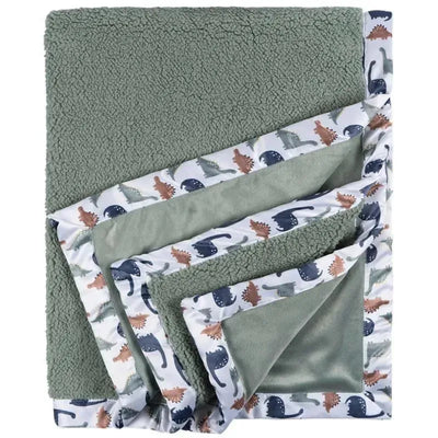 Plush dinosaur-themed blanket featuring a soft green top and colorful dinosaur print border.