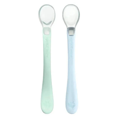 Light sage and light blueberry silicone spoons designed for infants by Green Sprouts, featuring a soft touch for first foods.