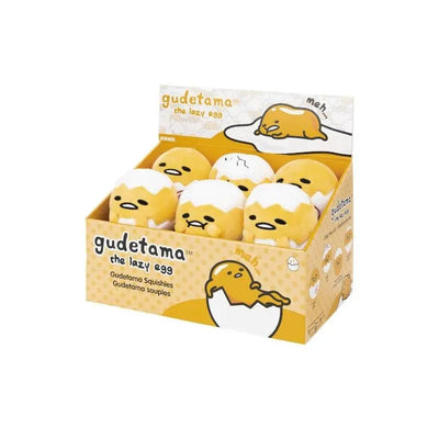 Gudetama Round Squishes Assortment featuring multiple yellow, egg-shaped plush toys with sleepy expressions, in a display box.