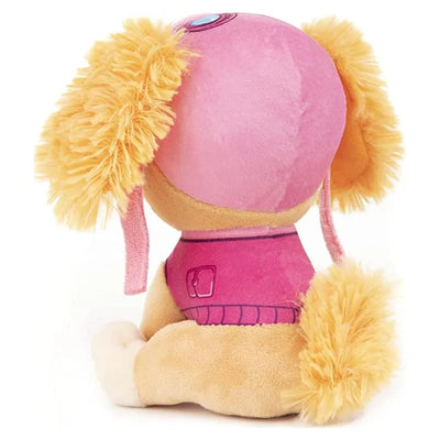 Plush toy of Skye from Paw Patrol, featuring a pink outfit and fluffy yellow ears, sitting upright.