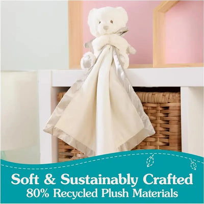 Gund Spiritual Bear Lovey features a soft, white bear attached to a beige blanket with a silver border, promoting sustainability.