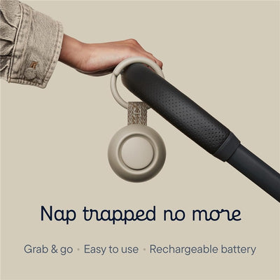 Hatch Go Portable Sound Machine in greige color, attached to a stroller handle, with text highlighting its easy portability features.