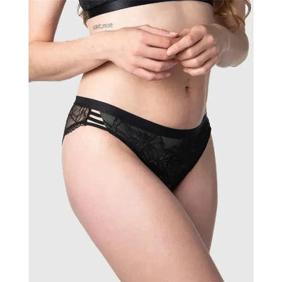 True Luxe Bikini in black featuring lace detailing and stylish side stripes, modeled by a woman.