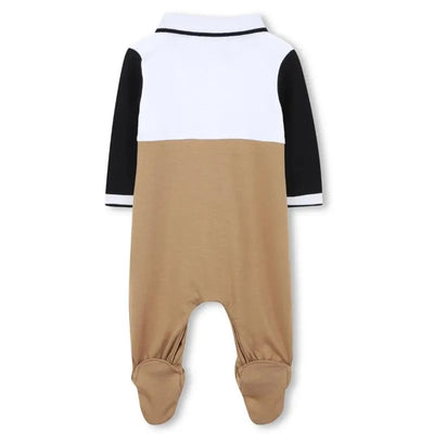 Beige polo footie for boys by Hugo Boss, featuring a white collar and black sleeves, designed for comfort and style.