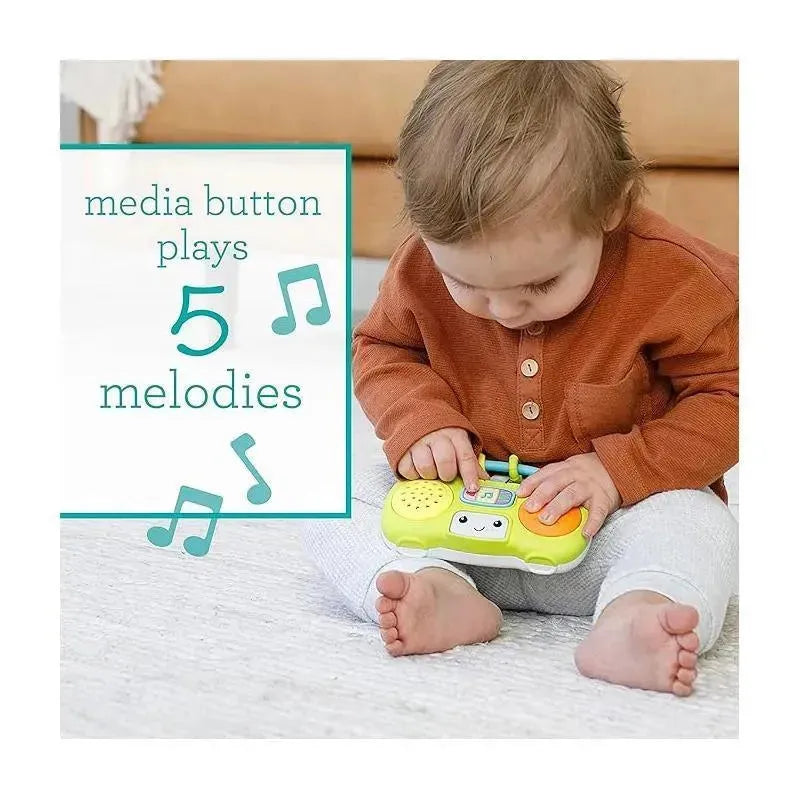Toddler in an orange shirt interacts with the Infantino Wee Wild Ones mini boombox, which plays five melodies.