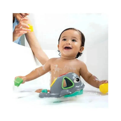Toddler enjoying bath time with Infantino Wee Wild Ones Orca the Whale toy, smiling while playing with bath blocks.
