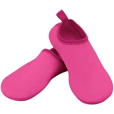 Pink Iplay water socks, size 7, featuring a smooth surface and a convenient pull tab at the heel.