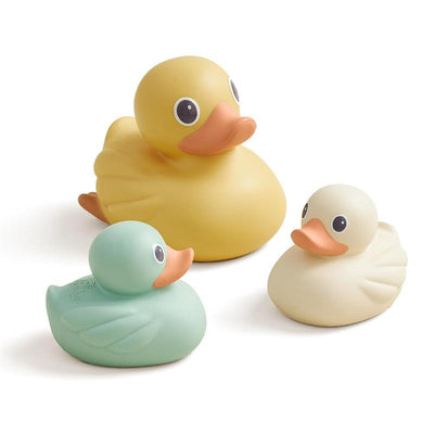 Three colorful floating bath toys shaped like ducks: one yellow, one green, and one white.