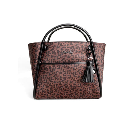 Itzy Ritzy Boss Tote Diaper Bag in leopard print with black trim and tassel detail, designed for parents.