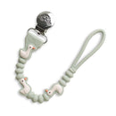 Paci strap featuring cute goose designs with a silver clip and a soft mint green cord for securing pacifiers.