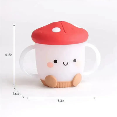 Itzy Ritzy Itzy Snack Cup in mushroom design, featuring a smiling face, red cap, and white body with handles.