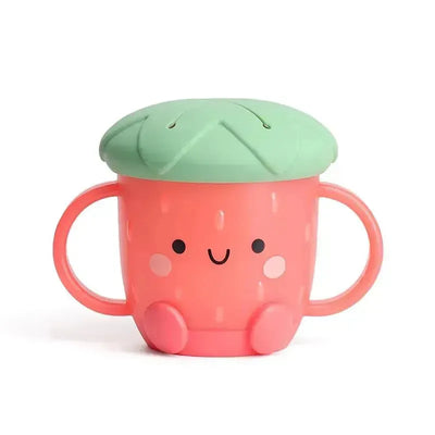 Itzy Ritzy Itzy Snack Cup™ in strawberry design, featuring a smiling face and green lid with slits, ideal for snacks.