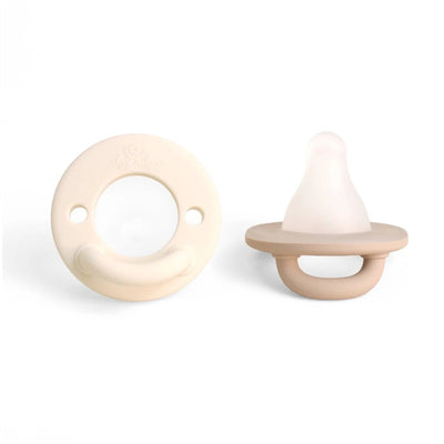 Taupe Itzy Ritzy Latch & Soothe Breastlike Pacifier featuring a soft silicone nipple and rounded, ergonomic shield.