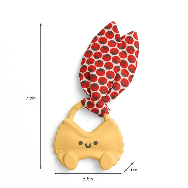 Pasta-shaped silicone teether in yellow with a smiling face, featuring a red tomato-patterned crinkle tie.
