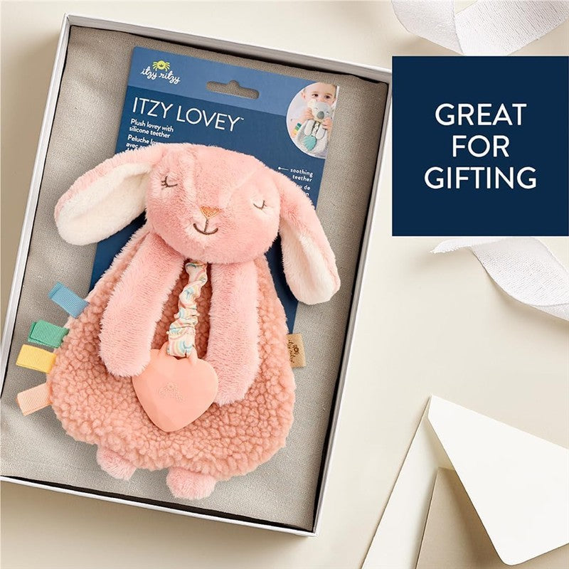 Pink bunny lovey with teether, featuring a soft plush design and colorful tags, presented in a gift box.