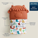 Silicone teething mitten designed for babies featuring a cow head, crinkle sounds, soft fabric, and hook & loop closure. BPA free.