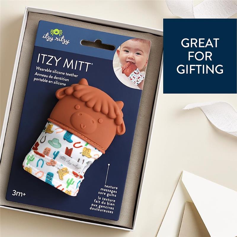 Silicone teething mitten designed as a cow, with colorful fabric featuring various patterns; suitable for infants 3 months and older.